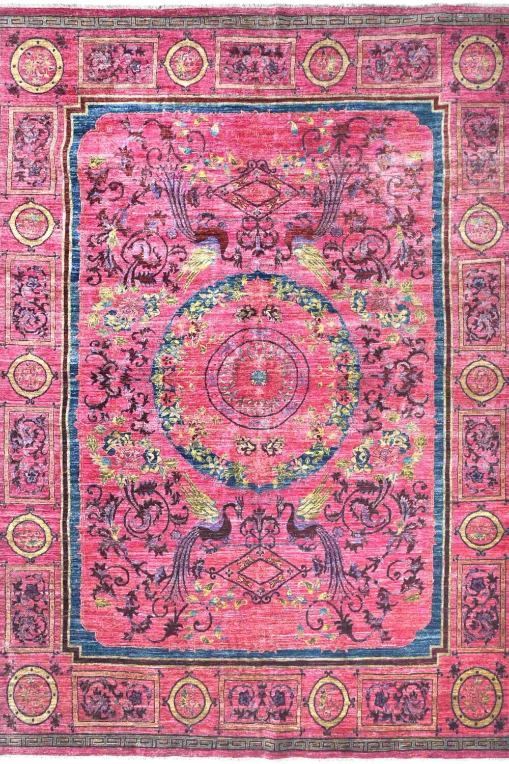 Vibrant Chobi rug in size 12' x 9' featuring intricate floral and geometric patterns in pink, blue, and yellow hues, perfect for adding a touch of elegance to a living room