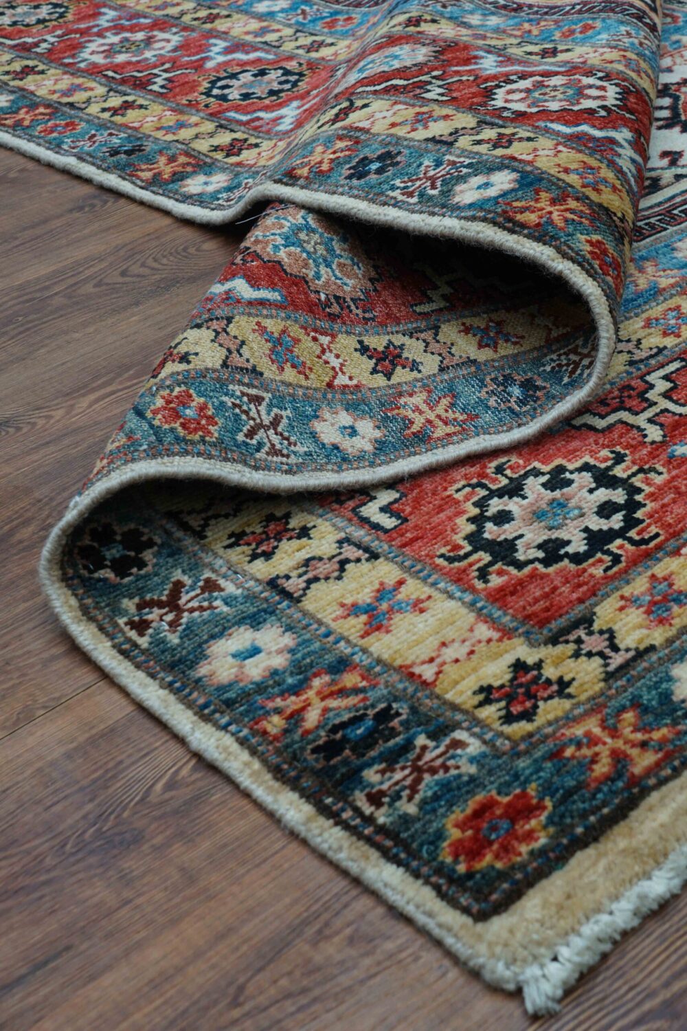 "6 x 8 beige rug with vibrant geometric and floral patterns, bordered by intricate multicolored designs, perfect for living spaces."