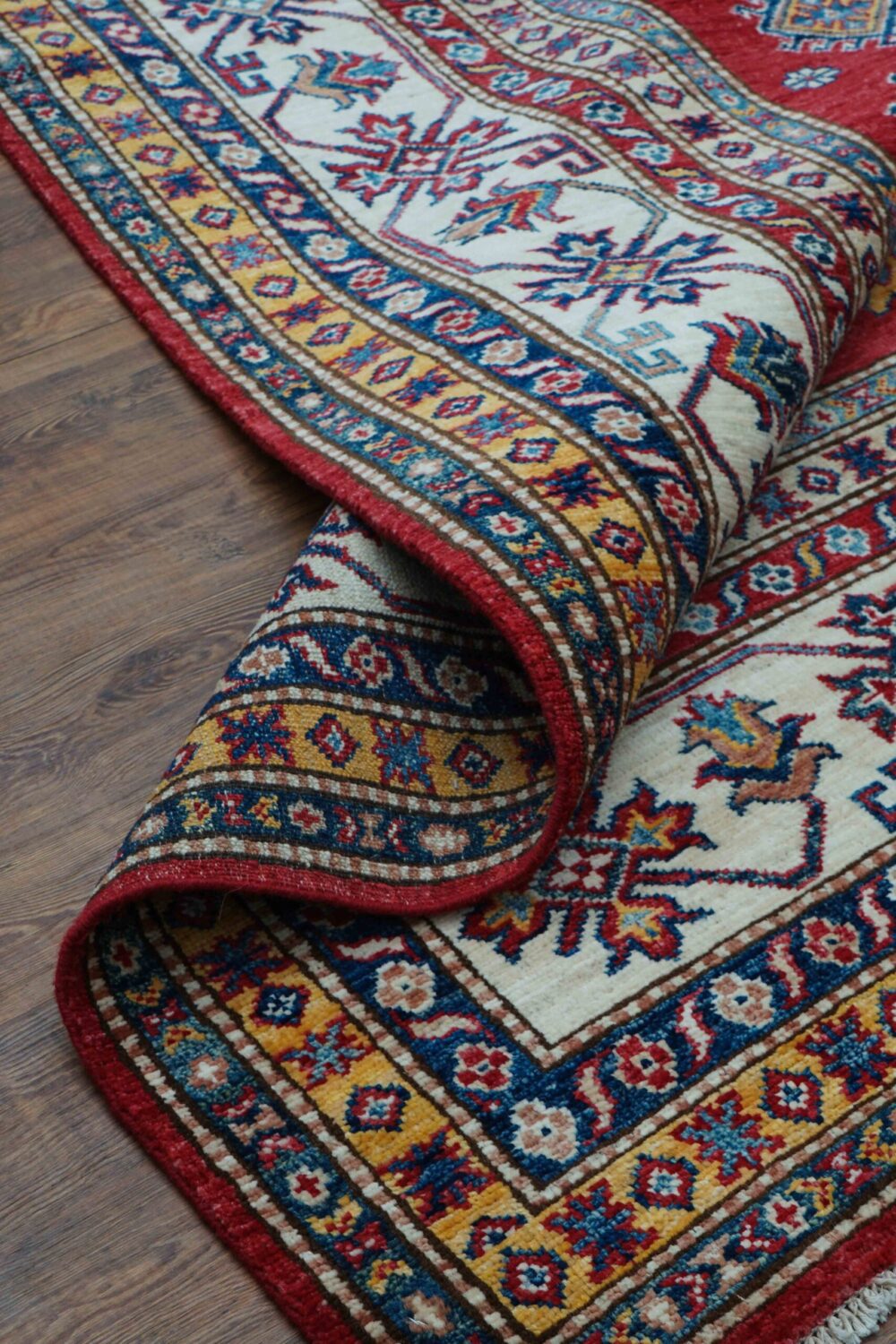 "Vibrant 6x8 red rug featuring intricate octagon patterns, floral accents, and contrasting white borders, perfect for wood floors."