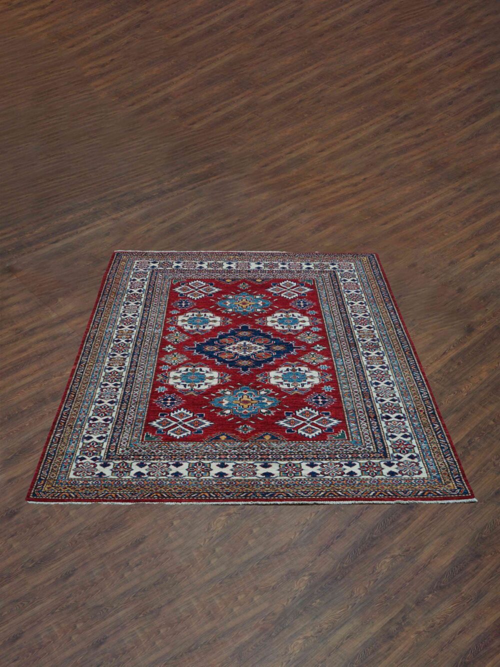 Super kazzak Vibrant red 5 x 6 rug featuring intricate floral and geometric patterns in rich shades of blue, ivory, and gold. The bold central design is framed with detailed multicolor borders, adding elegance to any room decor."