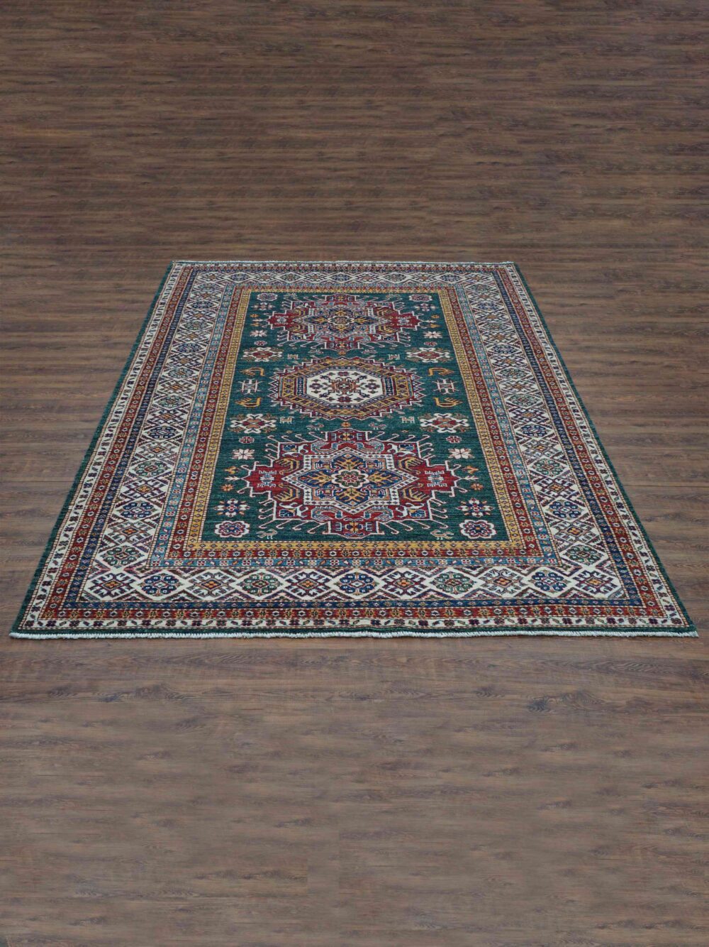 Super kazzak Luxurious 6 x 8 green rug featuring intricate red, blue, and ivory floral and geometric designs, framed by a detailed multicolored border. A timeless addition for a sophisticated and vibrant interior."