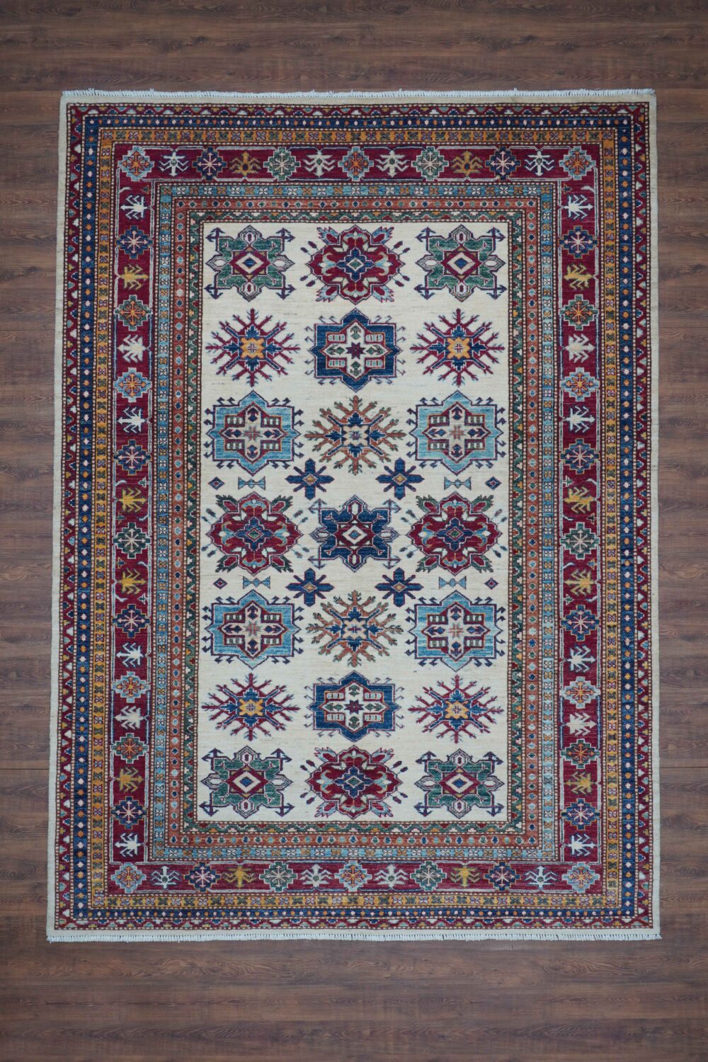 Super kazzak oriental rug 6 x 8 white rug featuring vibrant floral and geometric patterns in red, blue, and gold tones. Intricate borders enhance its beauty, making it a perfect centerpiece for living room rug to enhance room space