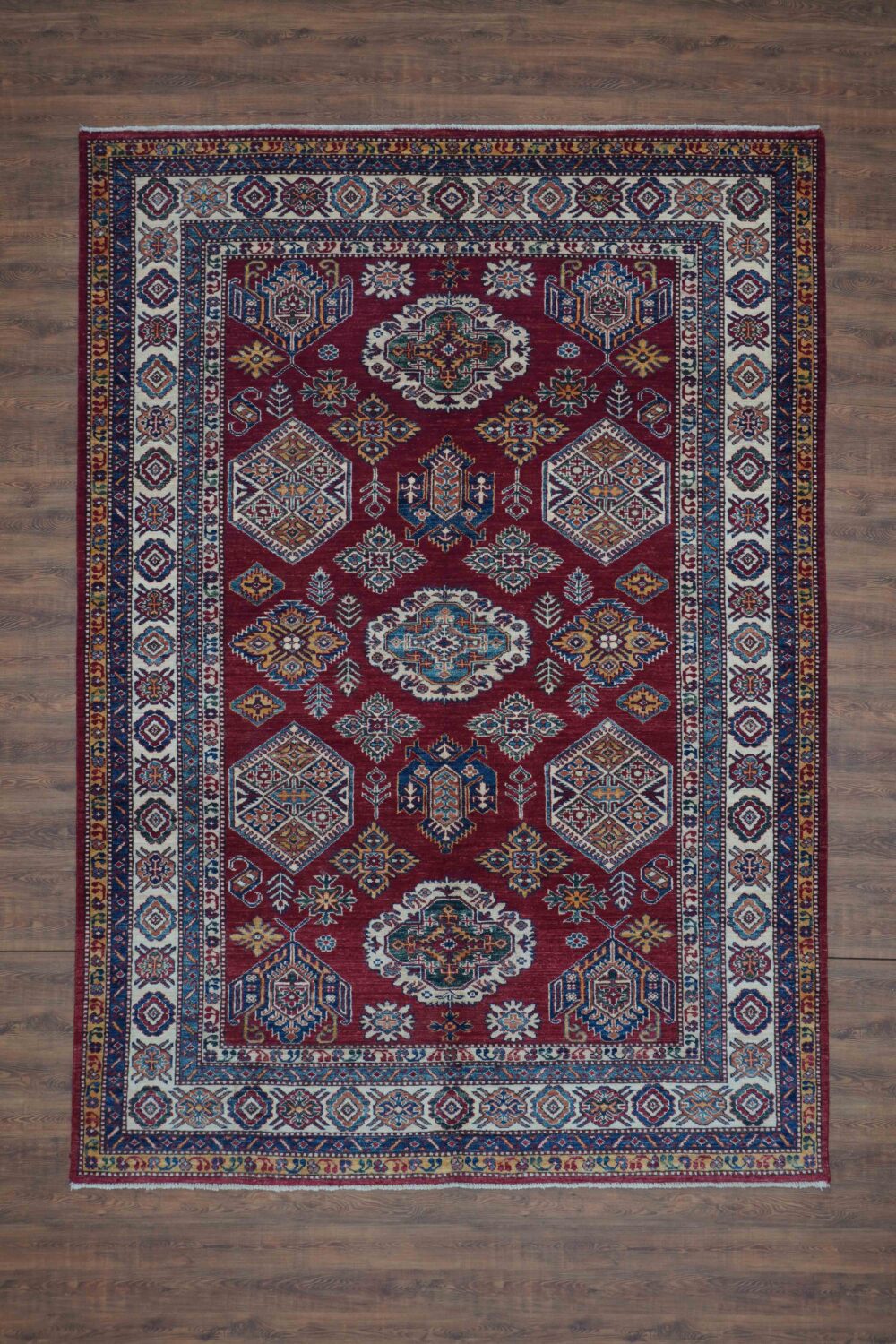 Super kazzak Traditional 6 x 8 red area rug featuring vibrant geometric and floral medallions, accented by a bold multicolored border for elegant decor.