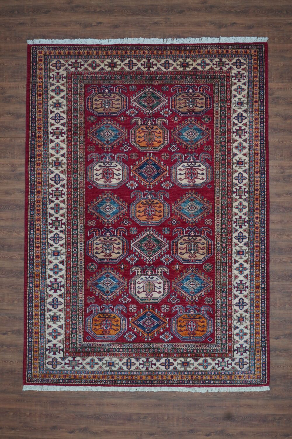 Super kazzak 6 x 8 red area rug with bold octagonal and floral motifs, vibrant multicolored geometric designs, and an intricate white-bordered frame