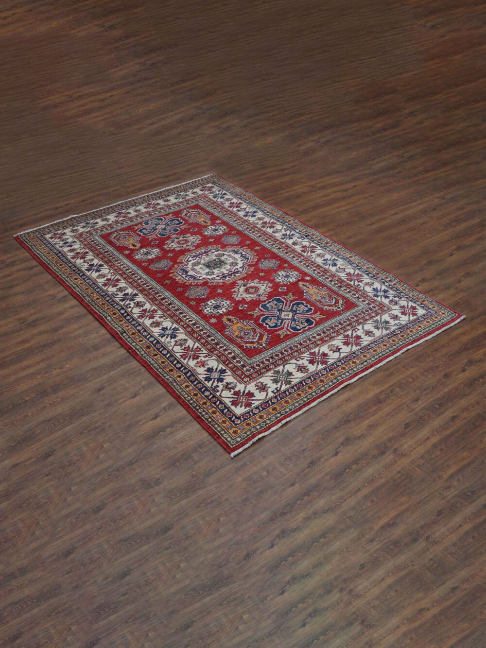 Super kazzak 6 x 8 rich red rug featuring intricate white and blue geometric medallions, surrounded by multicolored floral borders on a wooden floor.