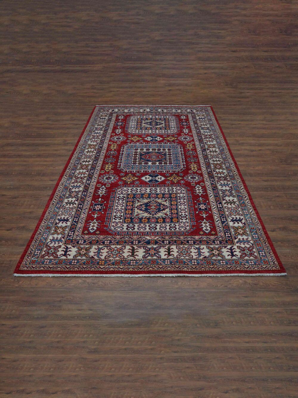 Super kazzak traditional 5x8 rug featuring a rich red background with detailed motifs in blue and white, framed by ornate floral and geometric borders, designed for use in a living room rug.